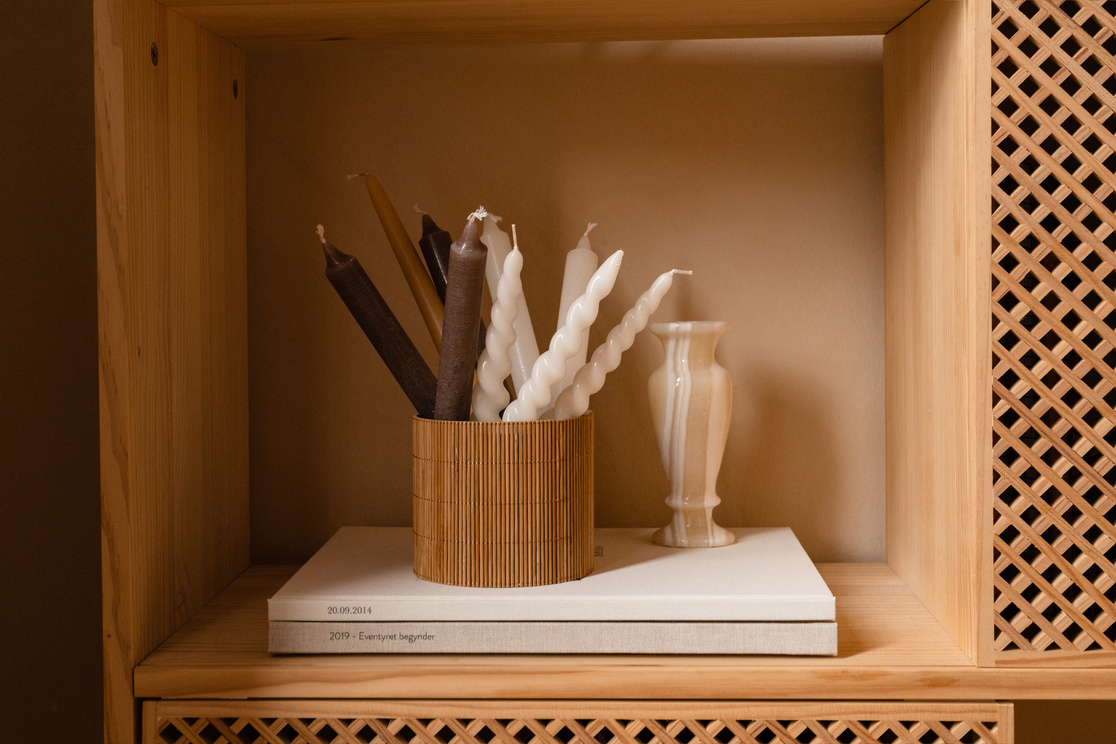 Candles and Magazines on Wooden Shelf