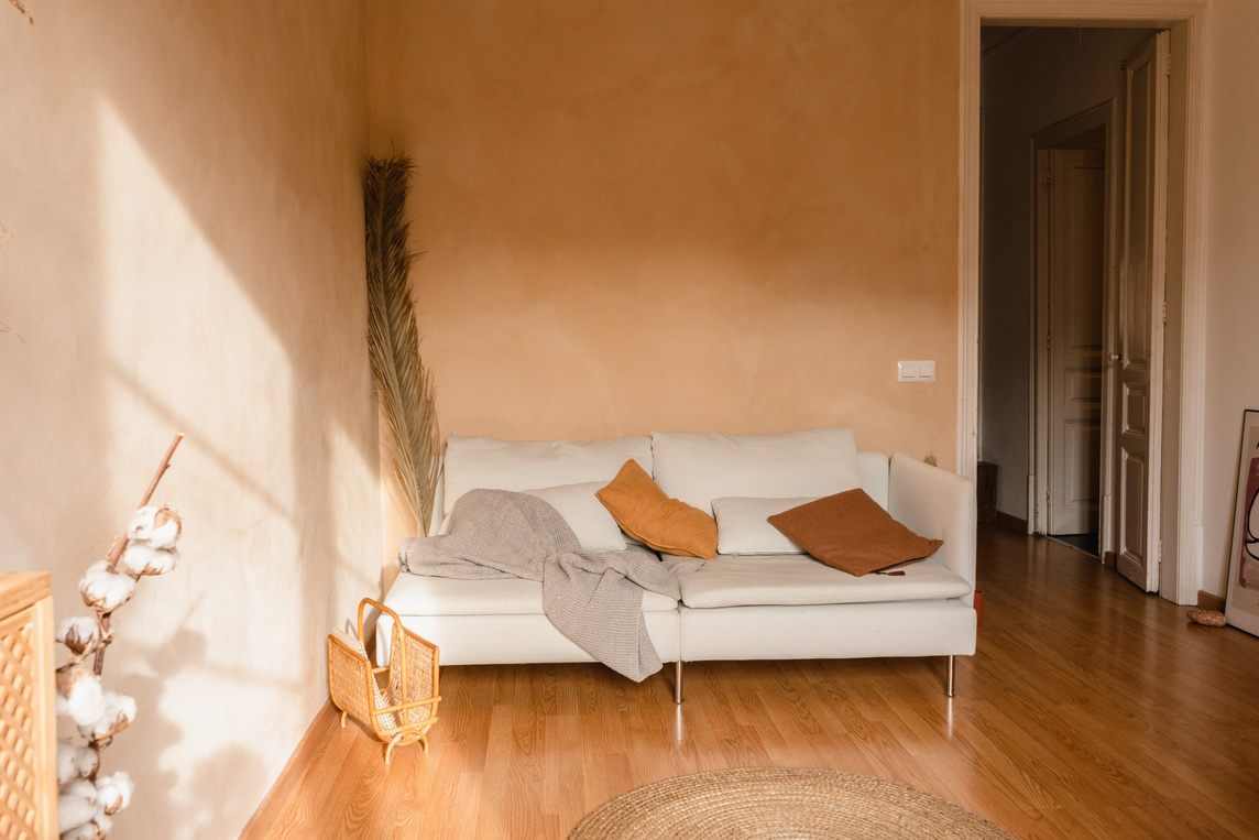 White Couch with Pillows and Plaid